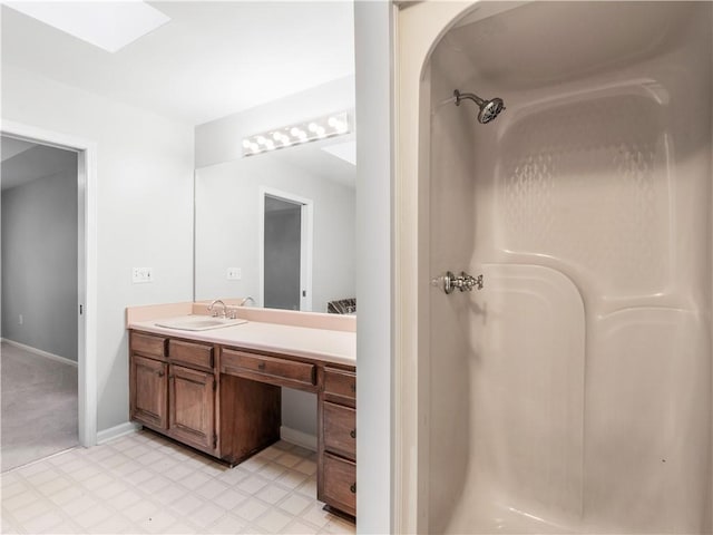 bathroom with vanity and a shower