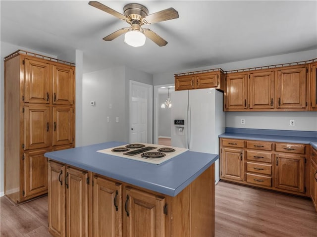 kitchen featuring ceiling fan, light hardwood / wood-style flooring, white appliances, and a kitchen island