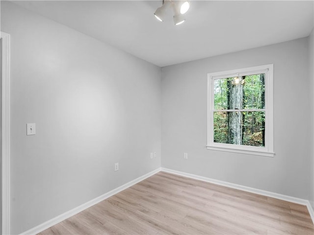 empty room with light hardwood / wood-style flooring