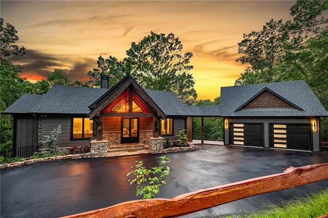 453 Settlers Ridge Rd, Ellijay, GA 30540 - view of front facade with asphalt driveway, an attached garage, roof with shingles, french doors, and stone siding