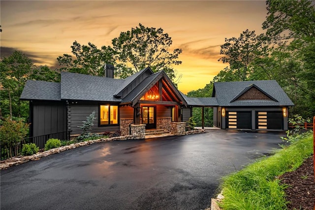 453 Settlers Ridge Rd, Ellijay, GA 30540 - view of front of house featuring driveway, a chimney, an attached garage, a shingled roof, and stone siding