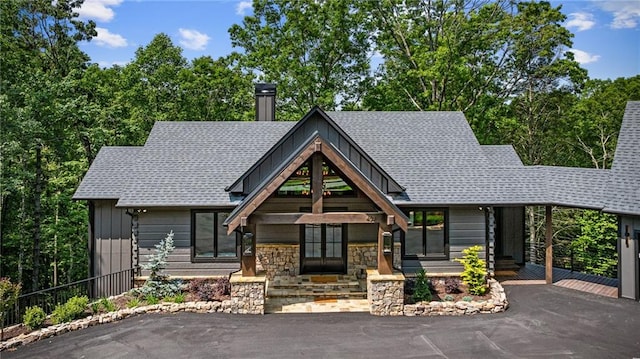453 Settlers Ridge Rd, Ellijay, GA 30540 - view of front of house featuring board and batten siding, a chimney, stone siding, and roof with shingles