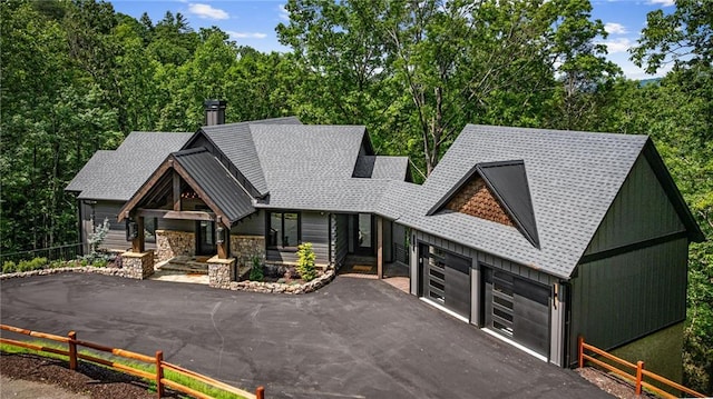453 Settlers Ridge Rd, Ellijay, GA 30540 - view of front facade featuring roof with shingles, asphalt driveway, a garage, and stone siding