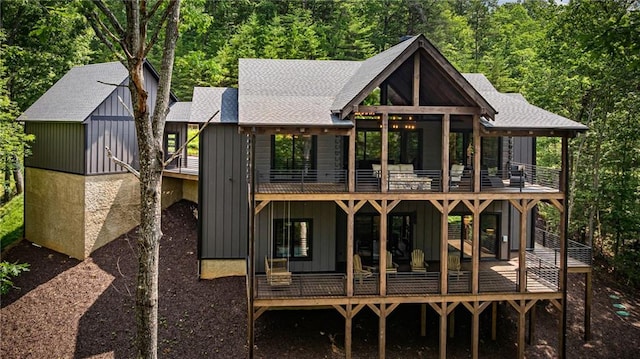 453 Settlers Ridge Rd, Ellijay, GA 30540 - back of house with a balcony, board and batten siding, a shingled roof, and a view of trees