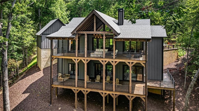453 Settlers Ridge Rd, Ellijay, GA 30540 - rear view of property with a balcony, a shingled roof, board and batten siding, and a chimney