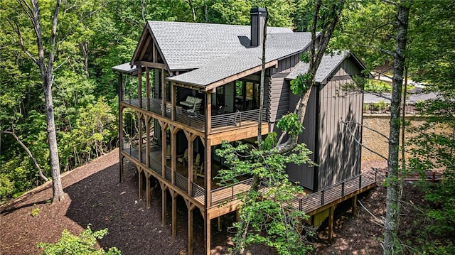 453 Settlers Ridge Rd, Ellijay, GA 30540 - rear view of property featuring roof with shingles, a wooden deck, a chimney, and board and batten siding
