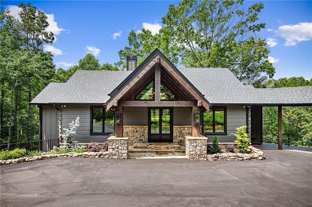 453 Settlers Ridge Rd, Ellijay, GA 30540 - view of front facade with a chimney, roof with shingles, a carport, and french doors