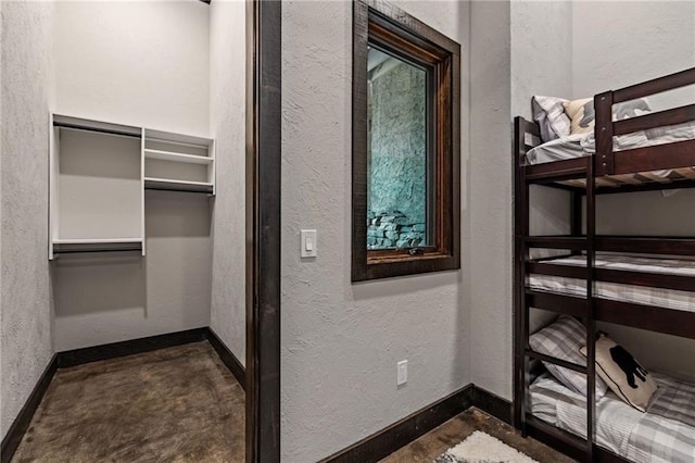 453 Settlers Ridge Rd, Ellijay, GA 30540 - unfurnished bedroom featuring a textured wall, unfinished concrete floors, and a closet