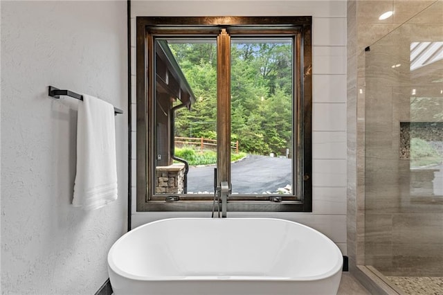 453 Settlers Ridge Rd, Ellijay, GA 30540 - bathroom featuring a soaking tub, a textured wall, and tiled shower
