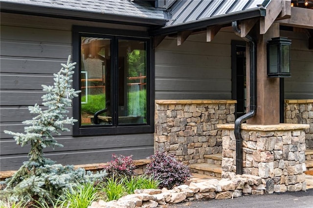 453 Settlers Ridge Rd, Ellijay, GA 30540 - exterior view of french doors, stone siding, a standing seam roof, and gutters