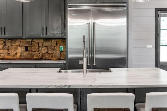 453 Settlers Ridge Rd, Ellijay, GA 30540 - kitchen featuring stainless steel built in refrigerator, gray cabinetry, light stone counters, and decorative backsplash
