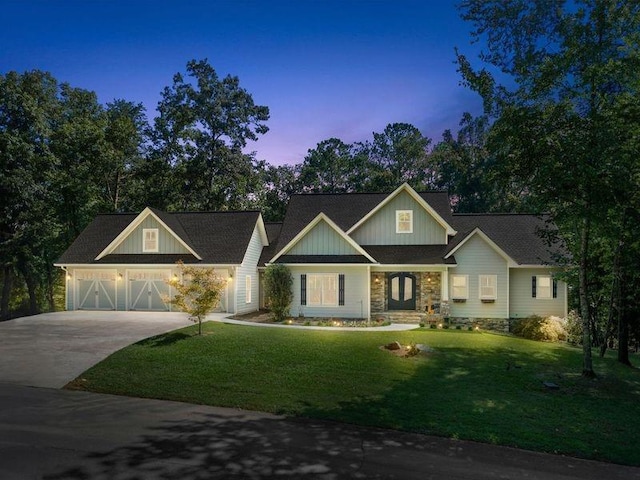 craftsman house with a garage and a lawn