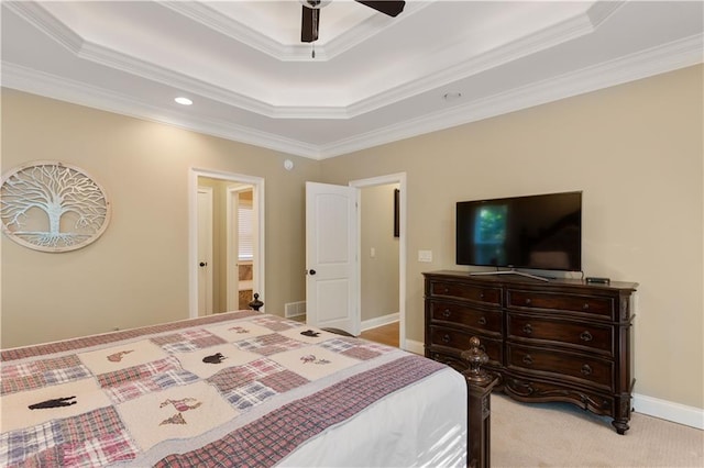 carpeted bedroom with ceiling fan, a tray ceiling, and crown molding