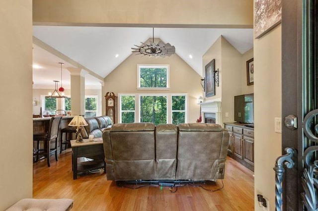 living room with lofted ceiling, light wood-type flooring, and ceiling fan