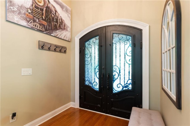 foyer with dark wood-type flooring and french doors