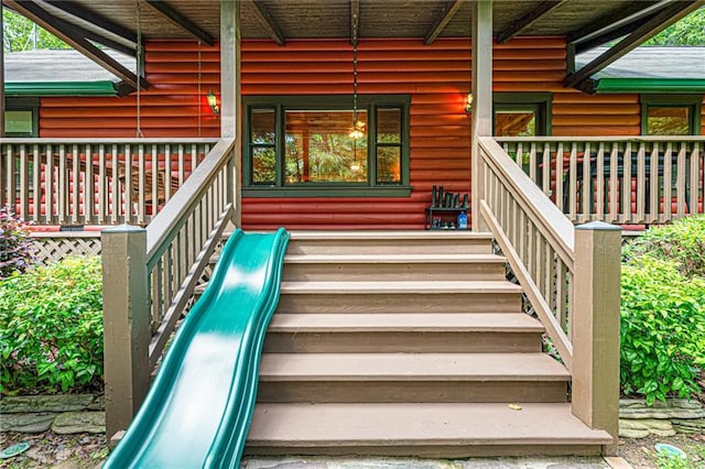 709 Deerfield Ln NW, Sugar Valley, GA 30746 - view of exterior entry with a porch and faux log siding