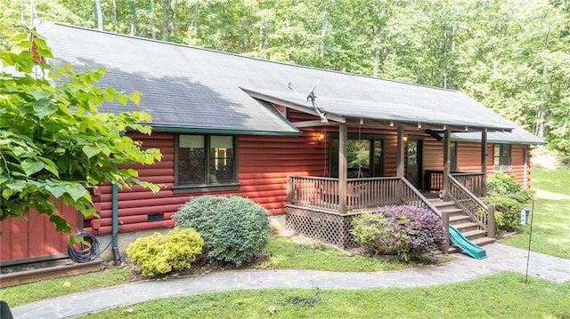 709 Deerfield Ln NW, Sugar Valley, GA 30746 - view of front facade featuring covered porch, log siding, and a front yard