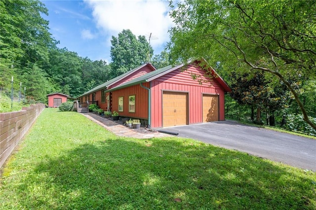 709 Deerfield Ln NW, Sugar Valley, GA 30746 - view of side of home featuring an outdoor structure, a lawn, and a detached garage
