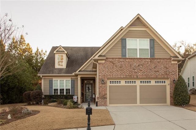 view of front of house with a garage, concrete driveway, and brick siding