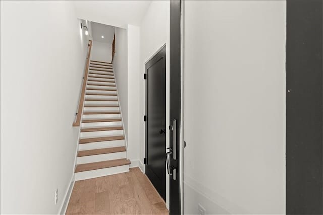 stairway with hardwood / wood-style floors