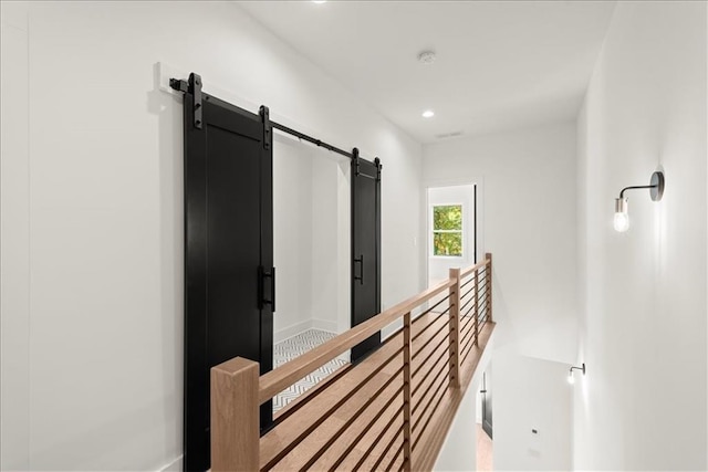 hall featuring a barn door