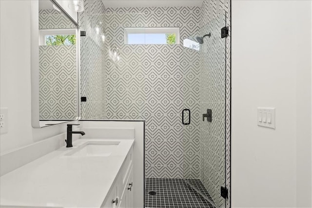 bathroom with walk in shower and vanity