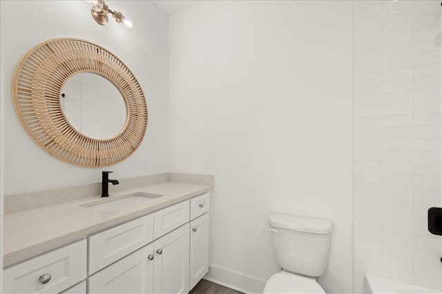 bathroom featuring toilet and vanity