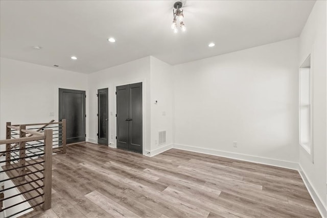 empty room with light hardwood / wood-style flooring