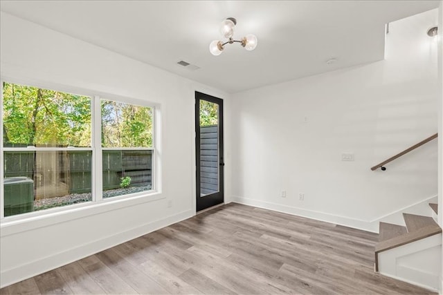 spare room with hardwood / wood-style floors