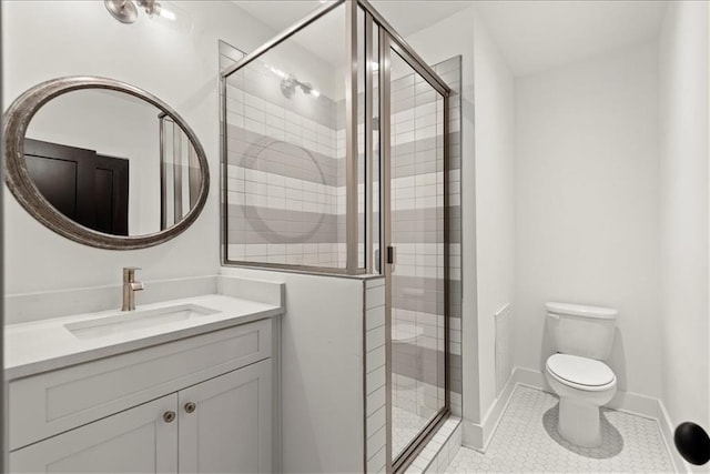 bathroom featuring toilet, vanity, and an enclosed shower