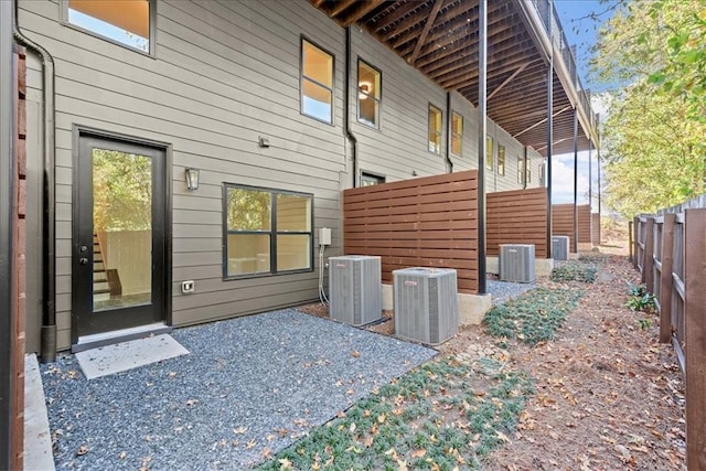 view of side of home with central air condition unit