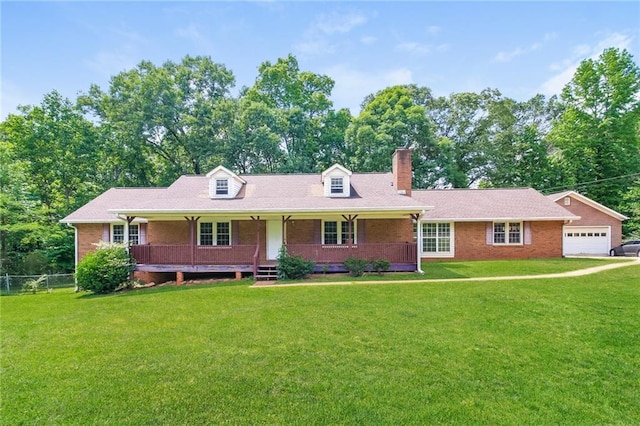 263 Austin Rd, Stockbridge, GA 30281 - new england style home featuring brick siding, a front yard, a chimney, and covered porch