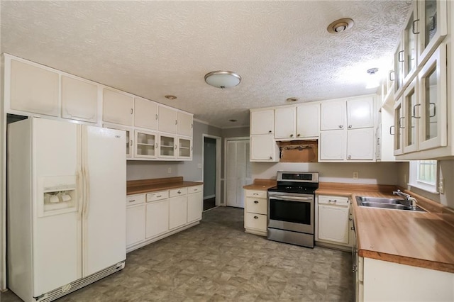 263 Austin Rd, Stockbridge, GA 30281 - kitchen with white refrigerator with ice dispenser, a sink, white cabinets, butcher block counters, and electric stove