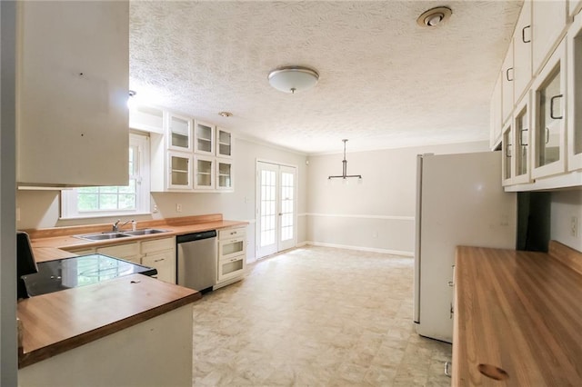 263 Austin Rd, Stockbridge, GA 30281 - kitchen featuring butcher block countertops, a sink, dishwasher, and white cabinets