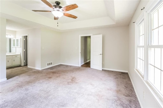 263 Austin Rd, Stockbridge, GA 30281 - unfurnished bedroom featuring visible vents, ensuite bathroom, baseboards, a raised ceiling, and carpet