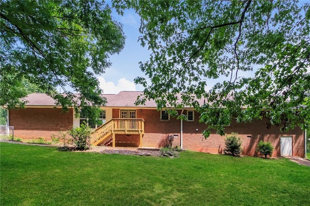263 Austin Rd, Stockbridge, GA 30281 - back of property with a lawn, a deck, stairway, and brick siding