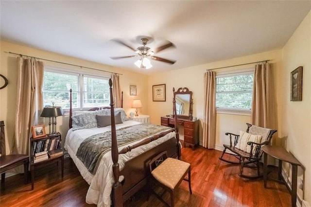 2889 Mount Olive Dr, Decatur, GA 30033 - bedroom featuring multiple windows, dark wood-style flooring, a ceiling fan, and baseboards
