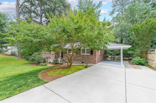 2889 Mount Olive Dr, Decatur, GA 30033 - view of property hidden behind natural elements featuring concrete driveway, brick siding, and an attached carport