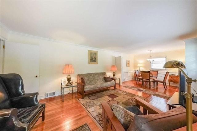 2889 Mount Olive Dr, Decatur, GA 30033 - living area featuring crown molding, wood finished floors, and a chandelier