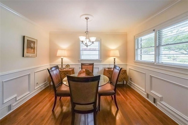 2889 Mount Olive Dr, Decatur, GA 30033 - dining area with a chandelier, dark wood-style floors, crown molding, a wainscoted wall, and a decorative wall