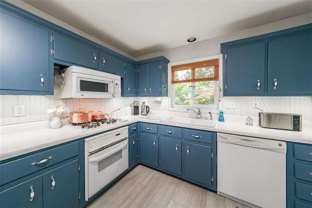 2889 Mount Olive Dr, Decatur, GA 30033 - kitchen featuring white appliances, a sink, light countertops, and blue cabinets