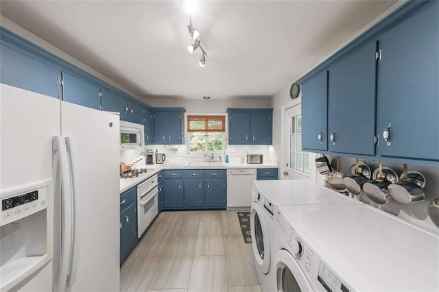 2889 Mount Olive Dr, Decatur, GA 30033 - kitchen with white appliances, washer and clothes dryer, blue cabinets, and light countertops