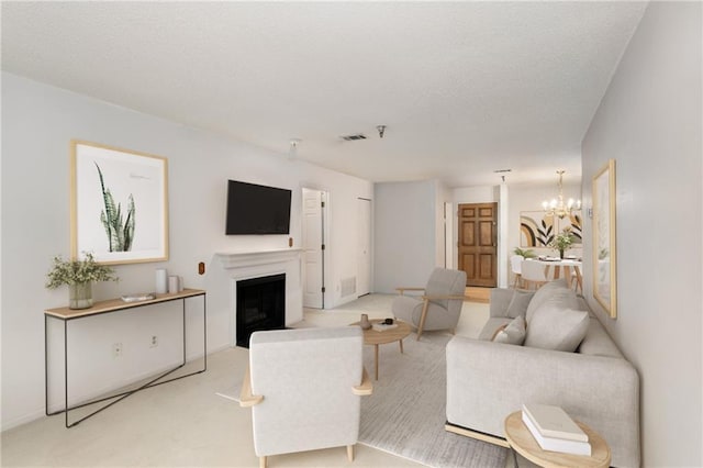 living room featuring light colored carpet, a textured ceiling, and a chandelier