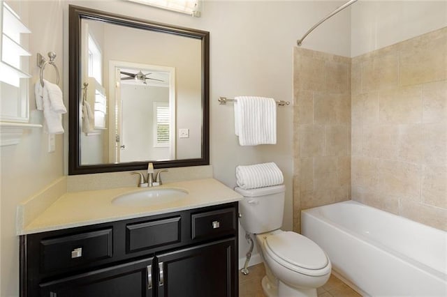 full bathroom with vanity, tiled shower / bath, tile patterned floors, and toilet