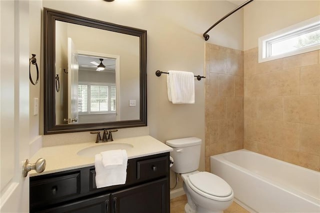 full bathroom featuring tiled shower / bath combo, vanity, plenty of natural light, and toilet