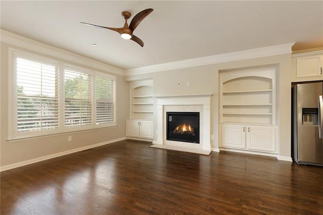 unfurnished living room featuring crown molding, dark hardwood / wood-style floors, and built in features