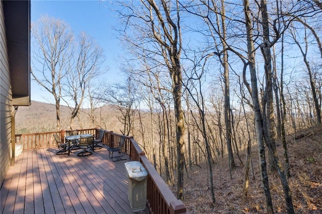 wooden terrace with outdoor dining area