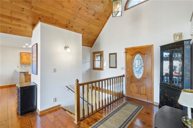 entryway with wooden ceiling, dark wood-style floors, a healthy amount of sunlight, and baseboards