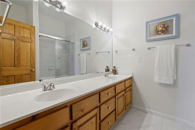 bathroom with double vanity, baseboards, a sink, and a shower with shower door