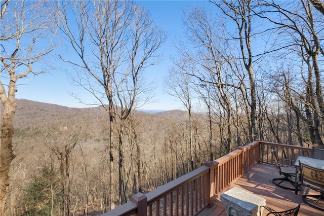 deck with a mountain view and a wooded view